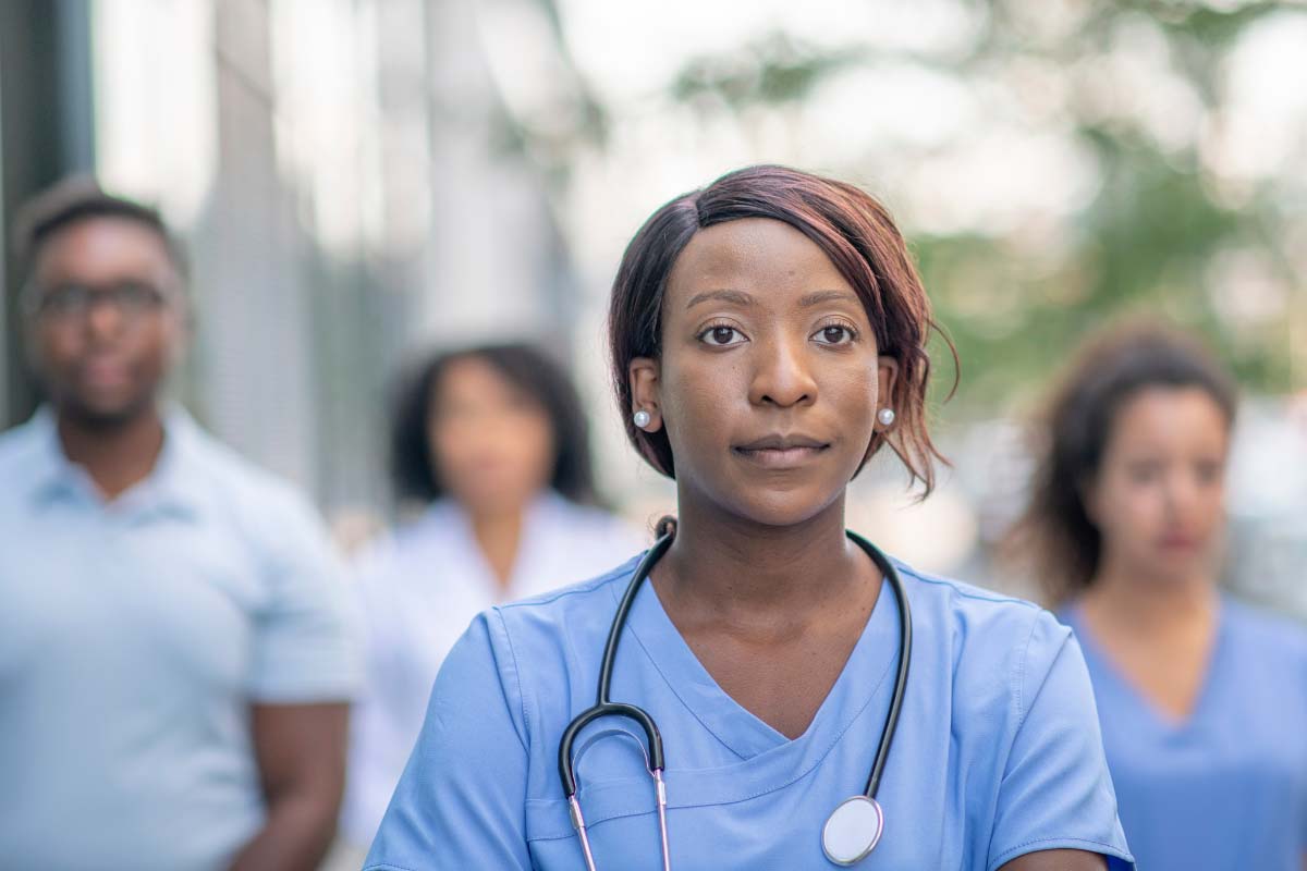 nurses standing outside a hospital