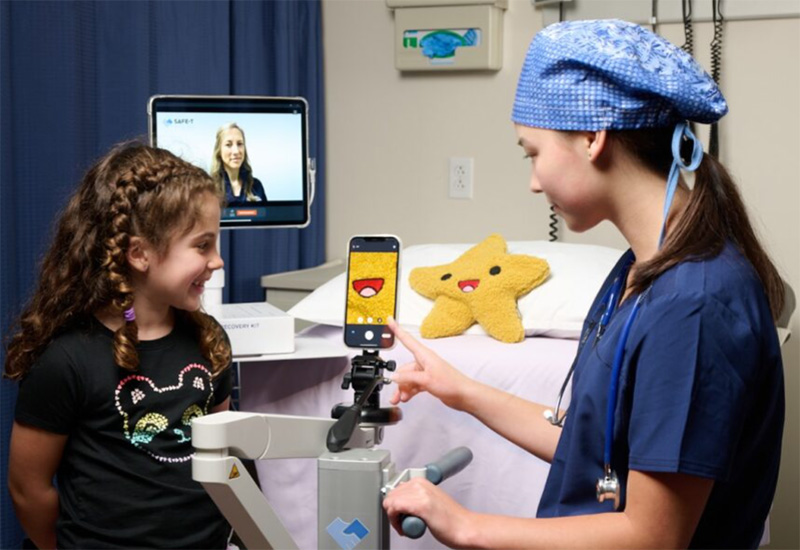 nurse demonstrating camera to a child with a stuffed star