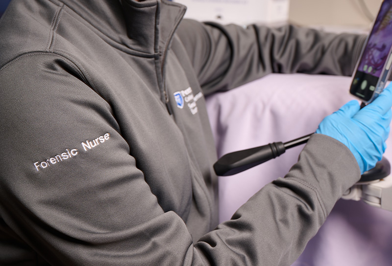 nurse wearing SAFE-T System jacket that reads "Forensic Nurse" on the sleeve